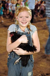 Jon Johnson Photo/Gila Valley Central: Kira Reed shows off the chicken she caught.