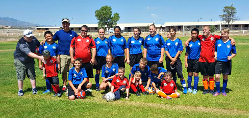 Contributed Photo: Courtesy of Hannah Keir/ The VIP team in their red uniforms pose for their first game alongside their co-players, the Blue Berries.