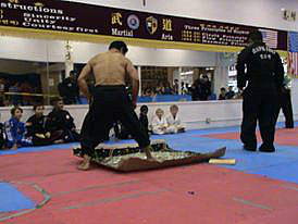Contributed photo by: Alissa Stockton/ Grand Master Kim Walking on glass during the Black Belt Award cerimony and demonstration