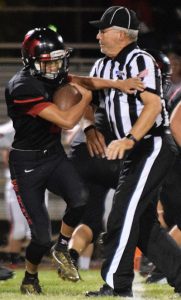 Contributed Photo/Courtesy Raymundo Frasquillo: Morenci junior Steven Chavarria (8) pushes the referee aside as he churns his way down the field. 