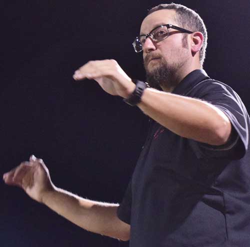 Photo By Raymundo Frasquillo: Morenci Pride Band director Jared Collins conducts the National Anthem during pre-game for home football contests in Lawson Stadium. Collins was recently feted during a banquet hosted by the Arizona Rural Schools Association at Little America in Flagstaff. During the gathering, the area resident was in the running for the 2016 Greenlee County Teacher of the Year award. He returned as a nominee along with a plaque. 
