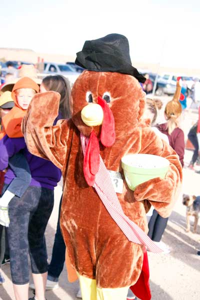 Jon Johnson Photo/Gila Valley Central: Stephanie Hoopes ran both races in her turkey mascot outfit and still had time to pass out candy to the children.