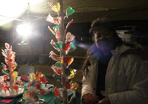 Brooke Curley Photo/ Gila Valley Central: Socorro Varela stands beside her candy tree, after having to restock it multiple times. 
