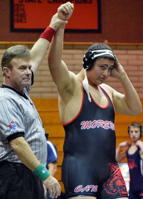 Photo By Raymundo Frasquillo: An official signifies the heavyweight match winner by lifting Morenci senior Jordan Arbizo’s hand in the air. 