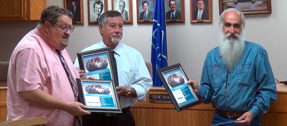 Jon Johnson Photo/Gila Valley Central: Outgoing council members, from left, Mayor Chris Gibbs, Ken Malloque and Jim Howes, display their plaques given in honor of their service. 