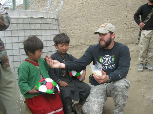Contributed Photo/Courtesy Chris Taylor: Chris Taylor works with Afghan children during his service augmenting a Special Forces team.