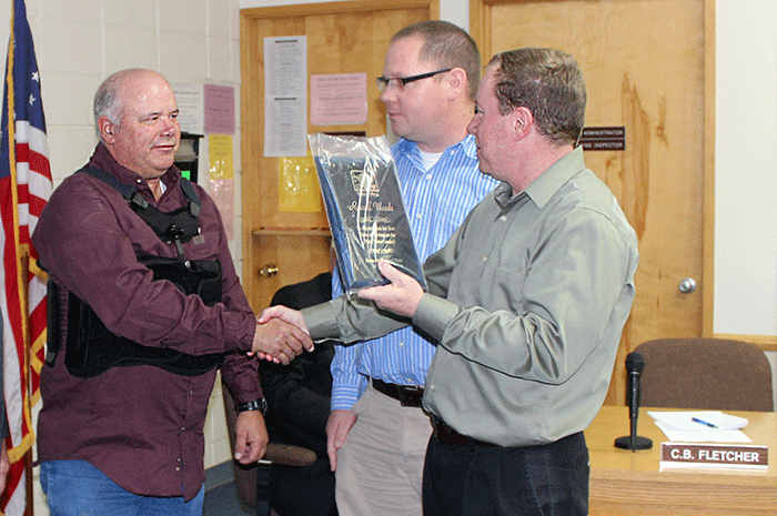 Brooke Curley Photo/ Gila Calley Central: Former council member Russle Woods (left)receives a plaque of appreciation from Town Manager McCormick 